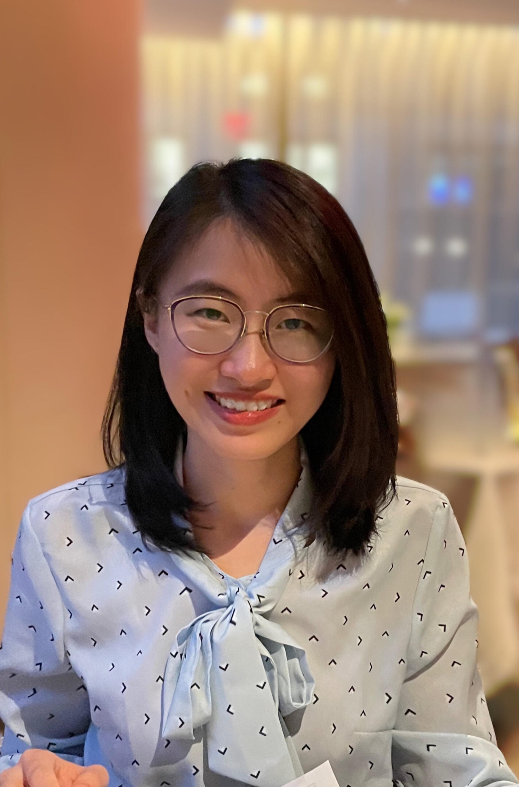 Shuting Yan wearing a white blouse with polkadots.
