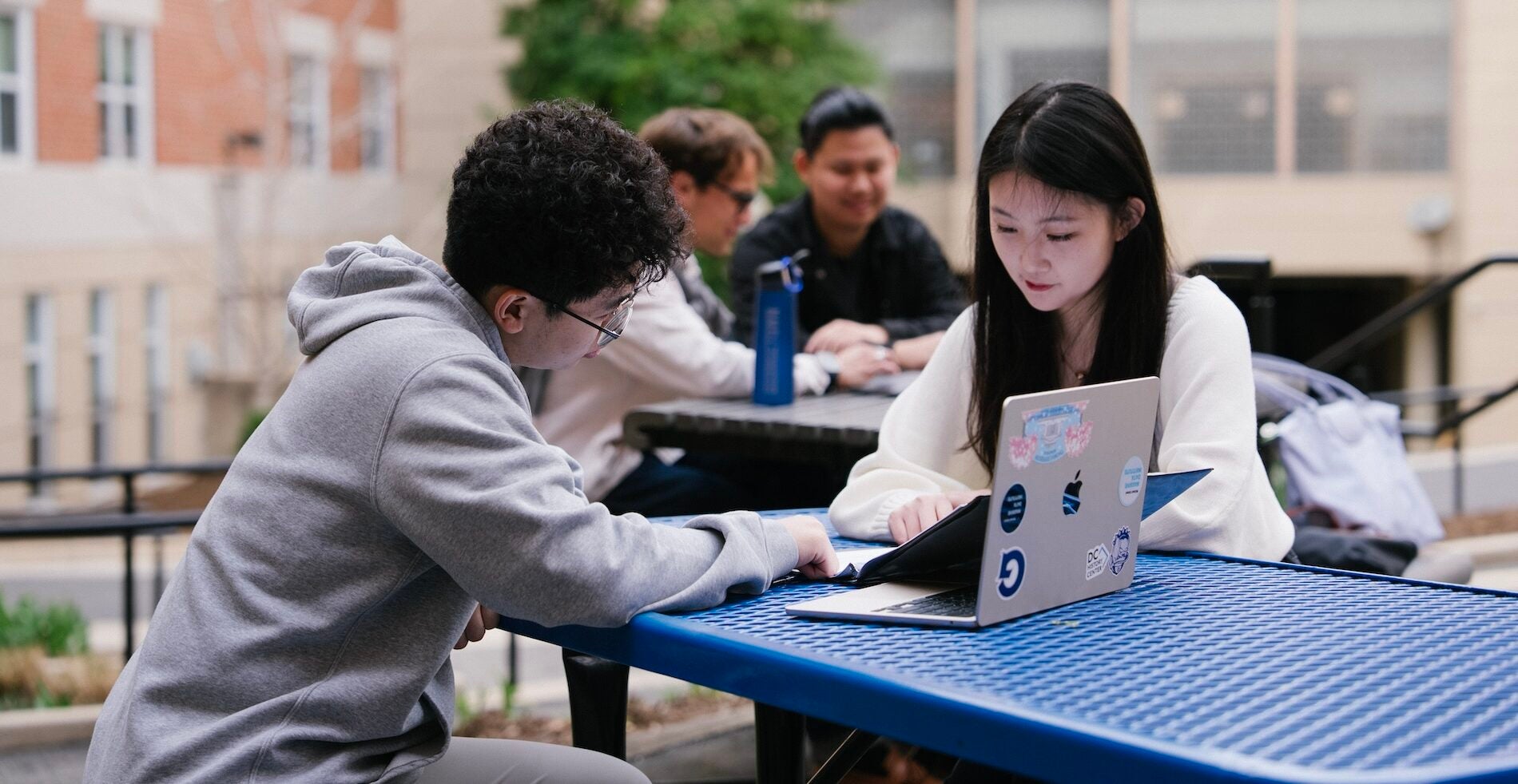 Students studying together at a tables.