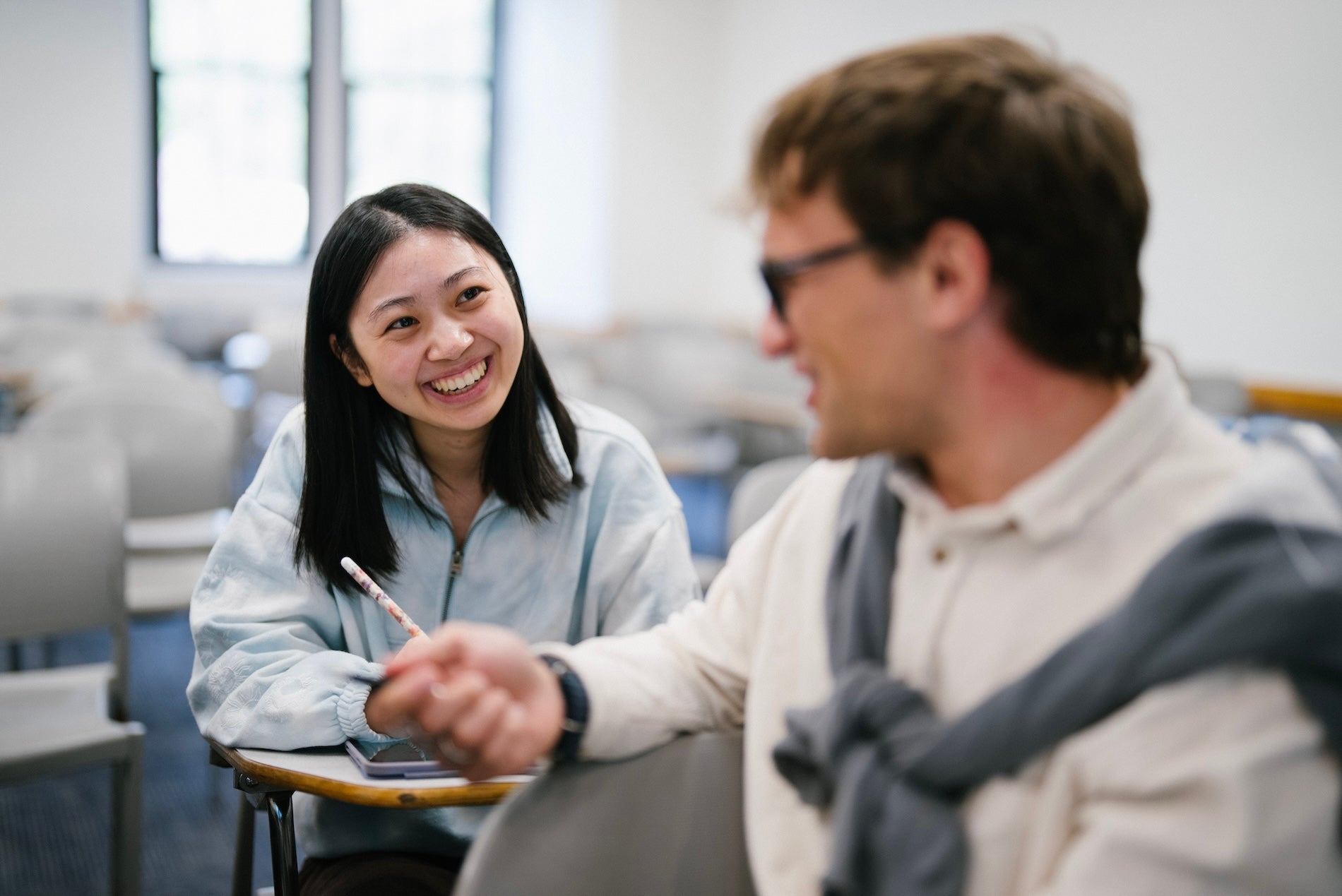 Two students talking in class.