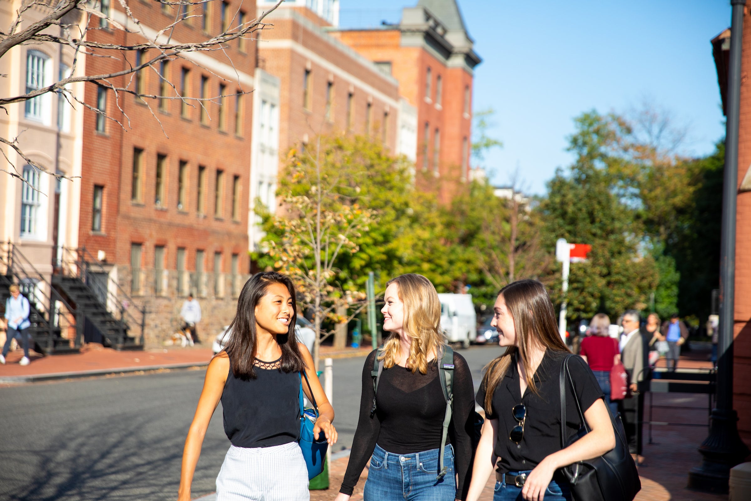 Grad students walking by the Grad programs building