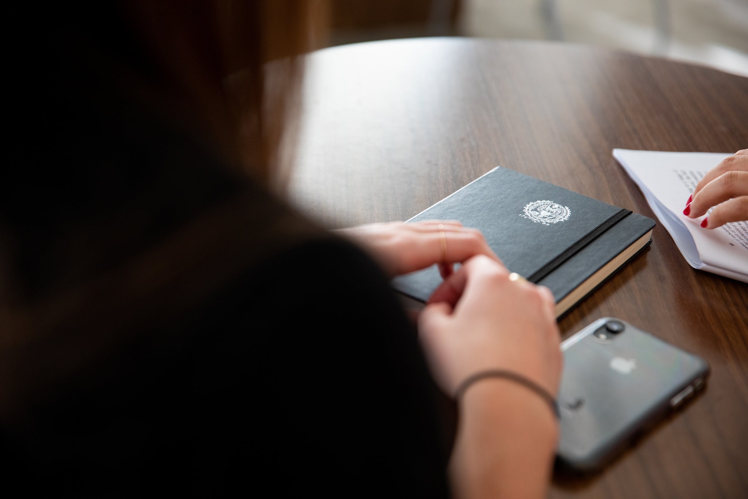 Grad student with a notebook at a table
